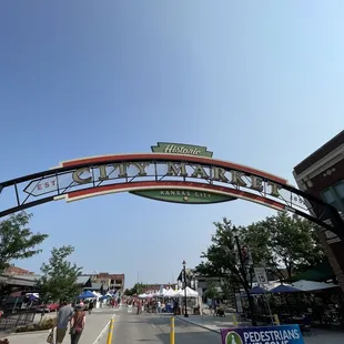people walking under the sign