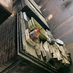 a wooden box with a bottle of beer on top of it