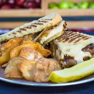 a grilled sandwich and potato wedges