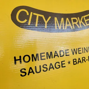 a sign for a sausage bar