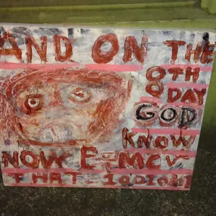 a painting of a man&apos;s face on a sign