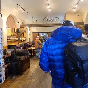 a man in a blue jacket and backpack