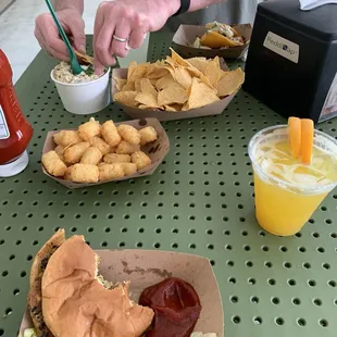 Pictured Veggie Burger, Al Pastor street taco, tater tots and elote street corn dip.
