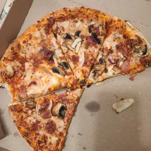 a half eaten pizza in a box