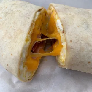 Breakfast wrap with egg, bacon, ham, cheddar