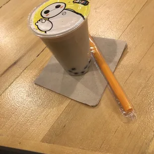 a cup of coffee and a straw