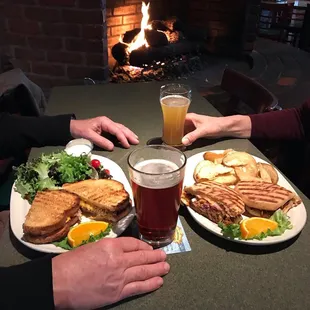two plates of food and a glass of beer