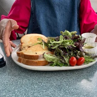 a woman sitting at a table with a plate of food