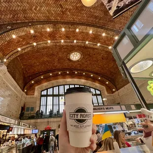 a person holding a cup of coffee