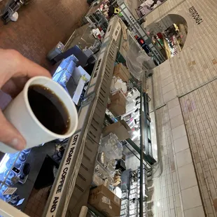 a person holding a cup of coffee