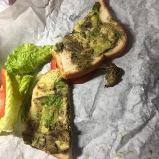 a sandwich with lettuce and tomato