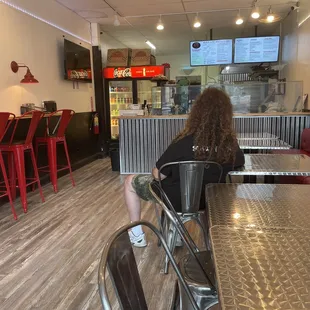 a woman sitting at a table in a restaurant