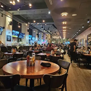 a busy restaurant with tables and chairs