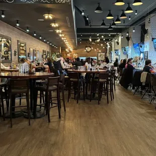 people sitting at tables in a restaurant