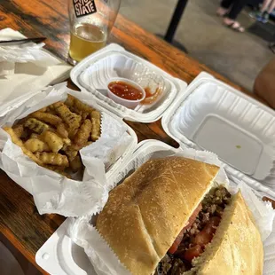 a sandwich and fries on a table