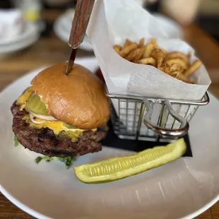a hamburger and pickle on a plate