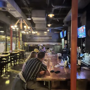 two people sitting at a bar