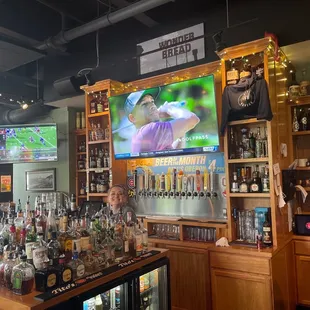 a man and a woman standing in front of the bar