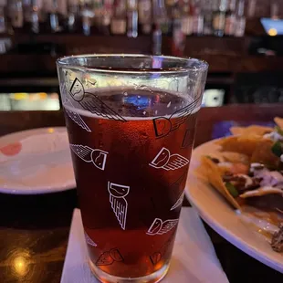 a glass of beer and a plate of food