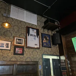 a television and a wall with pictures on it