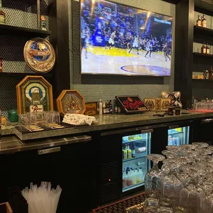 a bar with a large screen tv