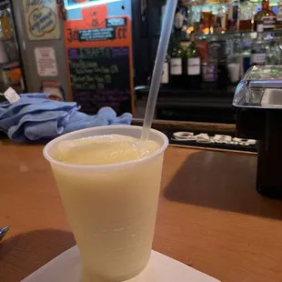 a drink in a plastic cup on a napkin