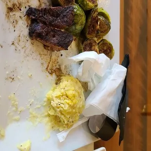 Steak, mashed potatoes, brussel sprouts and a bowl of chili.