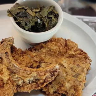 Fried pork chops with greens and  rice w/gravy.