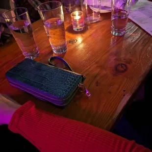 Trying to fit four adults at a two top table. My arm is on the outer edge of the table, legs not under the table