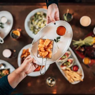 a person holding a plate of food