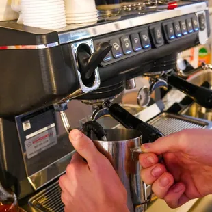 a person using a coffee machine