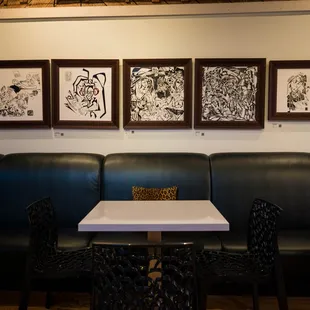 a black leather booth with a white table