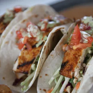 three fish tacos on a plate