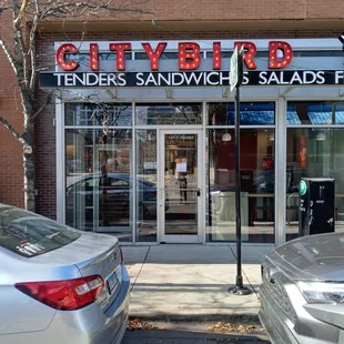 cars parked in front of a restaurant