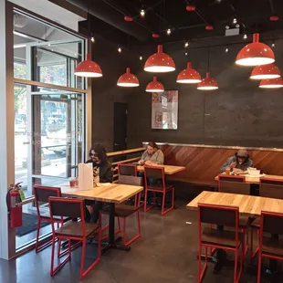 two people sitting at tables in a restaurant