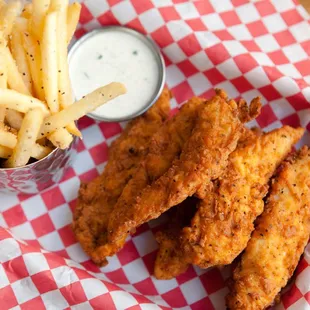 a basket of fried chicken and fries