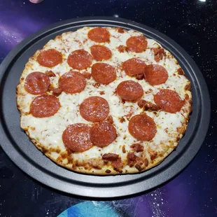 a pepperoni pizza on a tray
