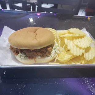 a sandwich and chips on a tray