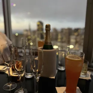 a bottle of champagne and glasses of wine on a table