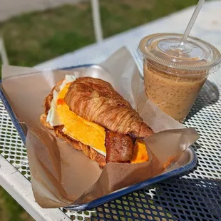 a croissant sandwich on a tray