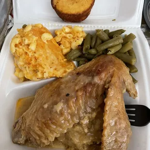 Smothered turkey wing over dressing, with green beans and mac.