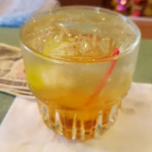 a drink in a glass on a napkin