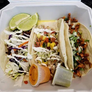 two tacos in a styrofoam container