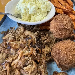 Pulled pork plate, potato salad, sweet potato fries, hush puppies