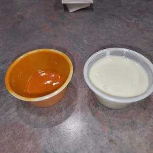 Here are the rationing tubs of blue cheese and buffalo mild sauce