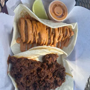 Fried fish taco (tilapia) and a chorizo taco on flour