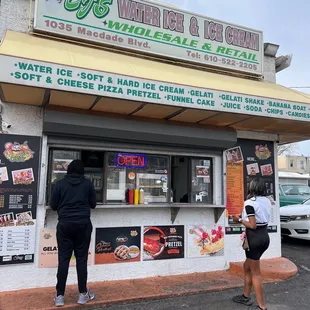 two people standing in front of a store