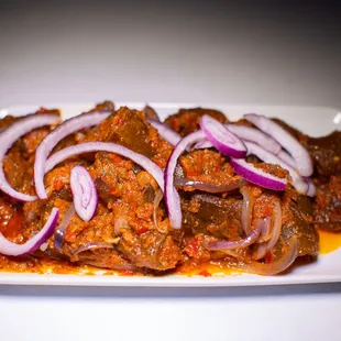 a plate of meat and onions