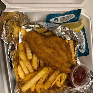 fish and fries in a styrofoam container
