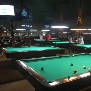 several pool tables in a bar